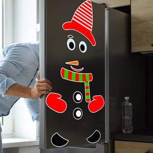 Detailed view of DIY Christmas snowman magnetic stickers on a refrigerator door