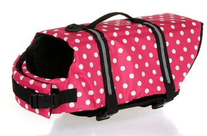 Detail of pink polka dot dog life jacket featuring a durable rescue handle and buckles