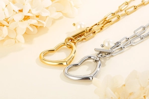 Detailed macro shot of gold and silver heart pearl paperclip chain necklaces set