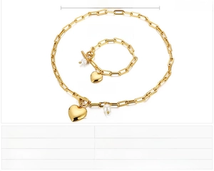 Détail de l'ensemble collier et bracelet doré en acier inoxydable avec pendentifs en cœur