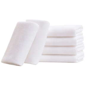Set of 6 white thick cotton hotel towels with fluffy texture and absorbent terry fabric