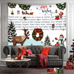Detail view of a Christmas tapestry with reindeer and snowman hanging over a modern sofa