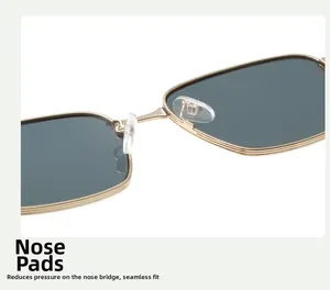 Detail of adjustable silicone nose pads and golden metal frame on square sunglasses