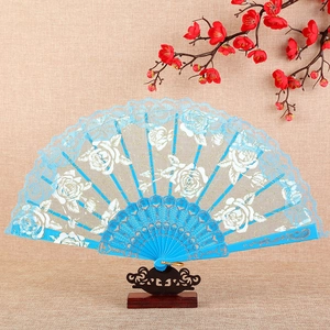 Light blue lace folding fan with gold embroidery and floral patterns on a wooden stand