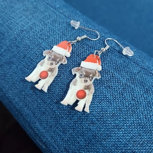 Detailed view of Christmas chihuahua acrylic earrings with red Santa hats and bells
