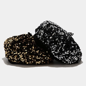Detailed view of dense sequin texture on fashion beret hats in gold and silver