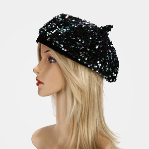 Close-up of sparkling black sequins on beret hat with iridescent metallic reflections