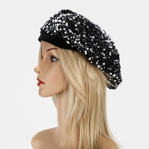 Detail of sparkly black and white sequins on a fashionable velvet beret for women