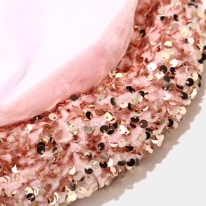 Close-up of pink velvet beret featuring shiny rose gold sequins and premium texture