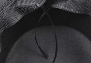Detail of adjustable inner drawstring and sweatband on a vintage black felt hat