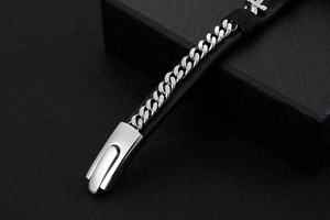 Detailed macro view of silver stainless steel chain bracelet with black leather details