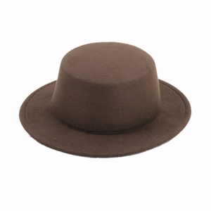 Macro shot of dark brown wool felt flat top boater hat with stiff texture and clean finish