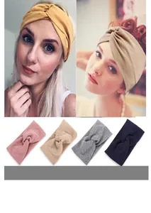Close-up of wide knotted headbands in six colors including yellow, beige and pink