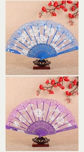 Detail of blue and purple lace folding fans with white rose patterns on wooden stands