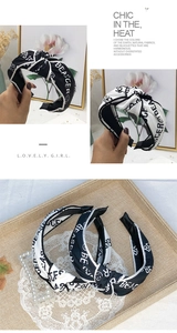 Detail of fabric knotted headbands with contrast edges and trendy letter print