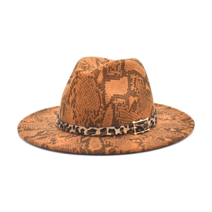 Macro view of snakeskin fedora hat featuring leopard band and gold square metal buckle
