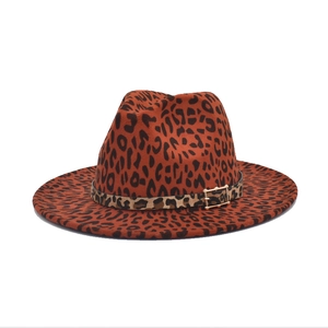 Detailed close-up of leopard print wool fedora hat with gold buckle decoration