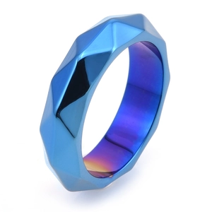 Macro view of mechanical geometric faceted stainless steel ring in blue and purple finish