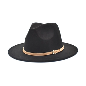 Detail of classic black wool fedora with a brown leather strap and gold metal buckle