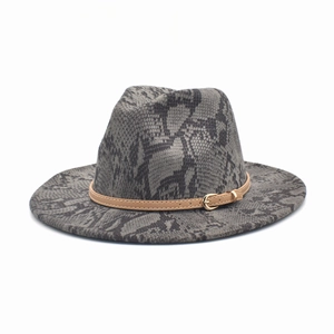 Detail of snake skin pattern fedora hat with brown leather band and gold buckle