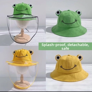 Detail of green and yellow frog-themed bucket hats with detachable protective face shields