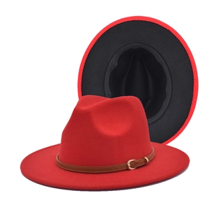 Detail of red fedora hat with brown leather belt buckle and black inner lining