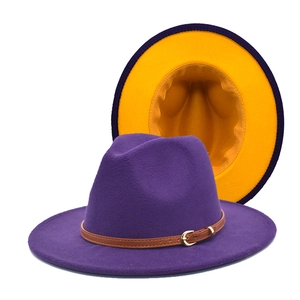Detail of two-tone wool fedora hat with purple exterior, yellow brim and leather belt