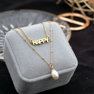 Double-layered gold titanium necklace featuring HAPPY letter pendant and a white pearl charm