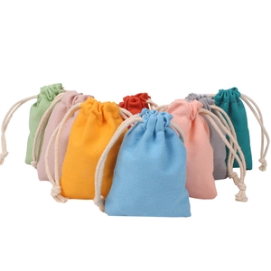 Colorful cotton drawstring storage pouches in multiple vibrant colors on white background