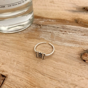 Detailed macro view of S925 sterling silver butterfly ring with engraved wing textures