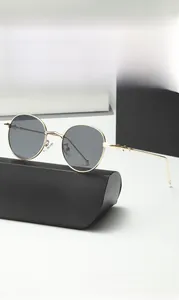 Detailed close-up of retro round metal sunglasses with geometric carved temple design