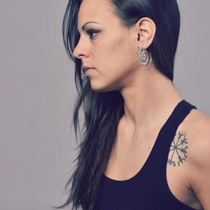 Boho style mandala pattern hollow circular hoop earrings in silver finish on a female model