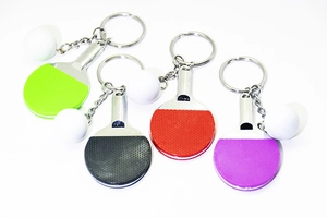 Detailed close-up of mini table tennis paddle keychains in green, black, red, and purple colors