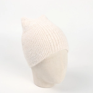 Detail of soft cream knit beanie with cute cat ears showing warm ribbed texture