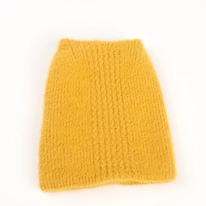 Detail of soft fuzzy bright yellow knitted skirt showing plush texture and warmth