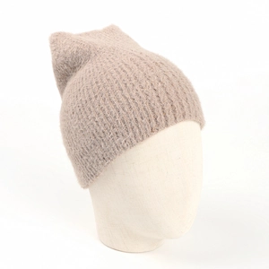 Close-up of cozy beige knit hat with fox ears on a model head stand for winter warmth
