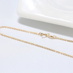 Macro shot of S925 sterling silver gold-plated cable chain with spring clasp detail