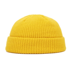 Detail of bright yellow chunky knit beanie showing thick texture and round crown design