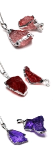 Detail of irregular natural crystal pendants with silver electroplated edges in three colors