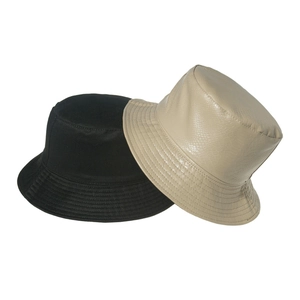 Flat lay of black canvas and beige crocodile pattern PU leather foldable bucket hats