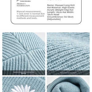 Detail view of light blue knitted beanie with daisy embroidery and high elastic fabric