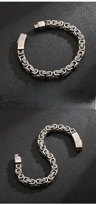 Macro shot of men's vintage Byzantine link bracelet showing antique stainless steel texture