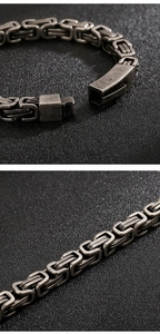Macro detail of antique silver Byzantine chain bracelet with plug-in buckle mechanism