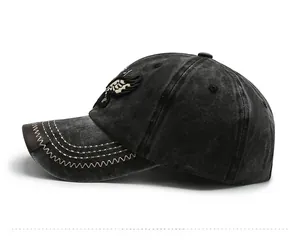 Detail view of vintage grey denim baseball cap featuring eagle embroidery and side profile