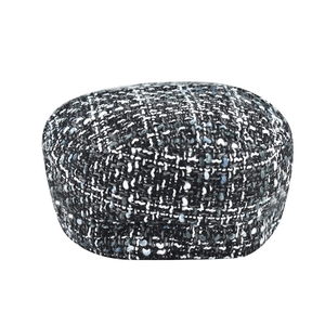 Close-up of black and white tweed newsboy hat showing detailed fabric texture and patterns