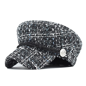 Detail of tweed newsboy hat with braided rope trim and silver decorative buttons