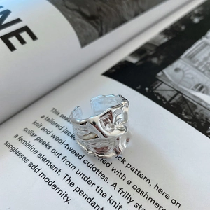 Macro detail of silver adjustable ring featuring a unique lava ripple texture on wide surface