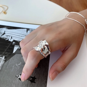 Macro shot of liquid lava style 925 silver irregular ring worn on model's hand