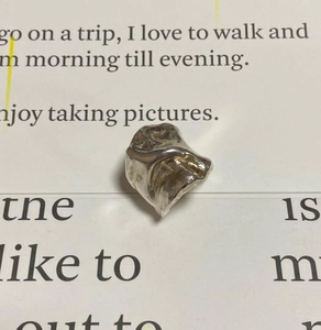Macro detail of silver irregular lava texture ring with modern industrial aesthetic