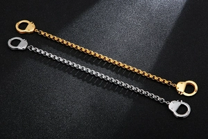 Detailed macro view of creative stainless steel handcuff bracelets in gold and silver